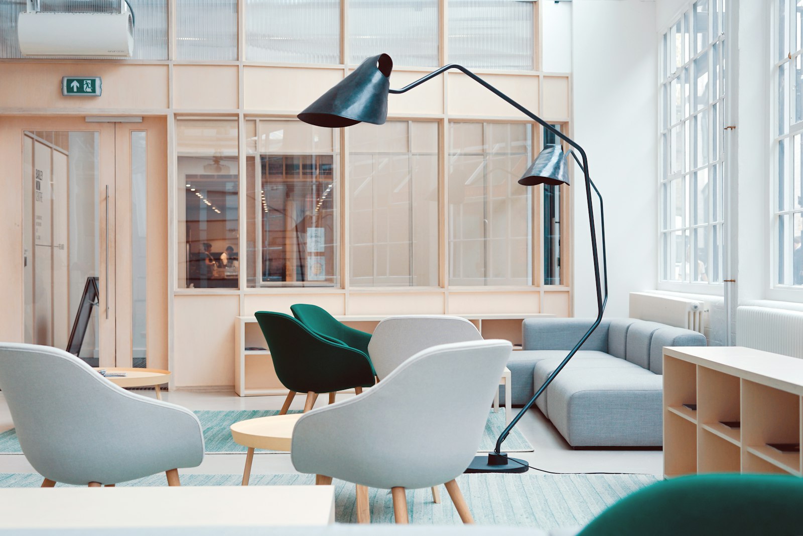 Arc floor lamp beside accent chairs