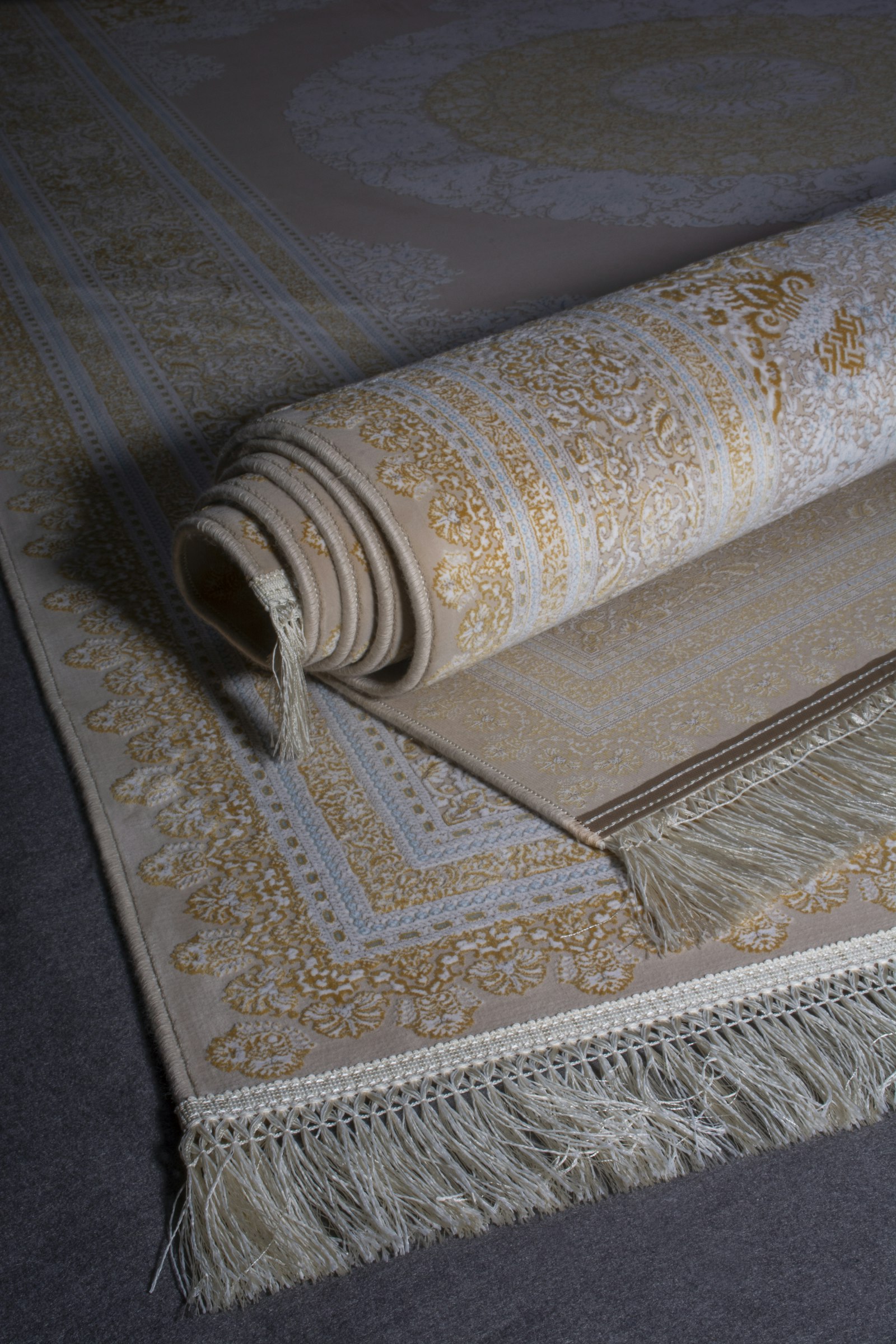 Hand-loomed area rug rolled on a wooden floor